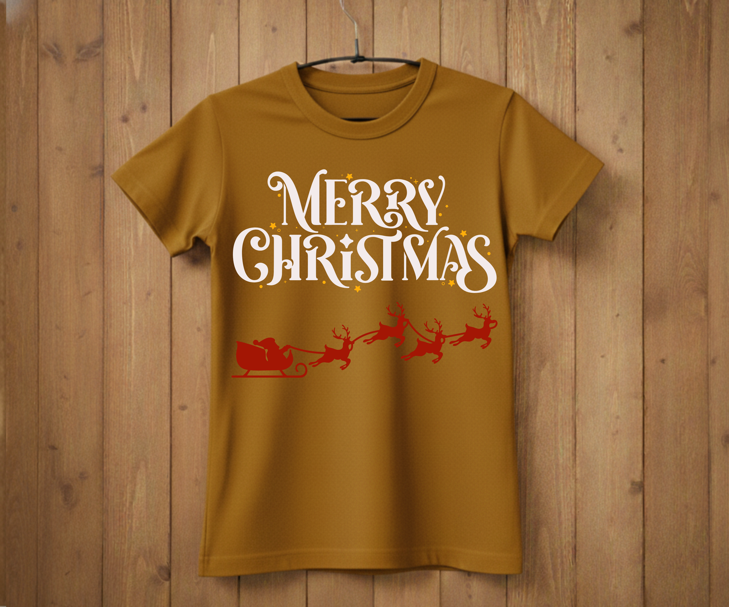 Brown t-shirt with 'Merry Christmas' text and Santa Claus graphic on a wooden background