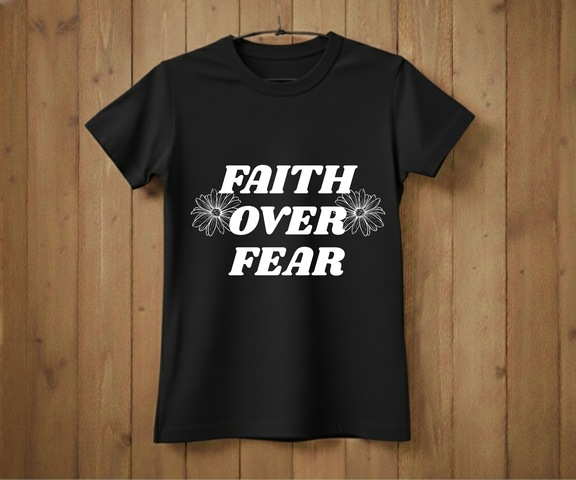 Black t-shirt with 'Faith Over Fear' text on a wooden background