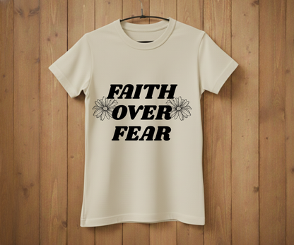 Beige t-shirt with 'Faith Over Fear' text on a wooden background