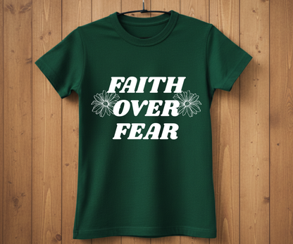 Green t-shirt with 'Faith Over Fear' text on a wooden background