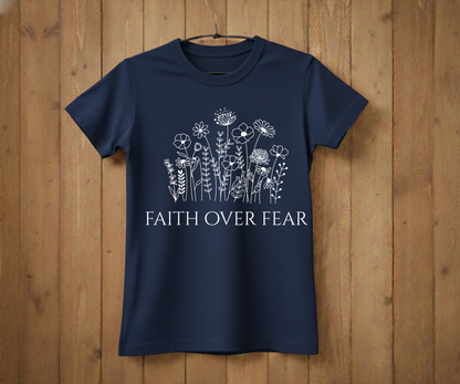 Navy blue t-shirt with floral design and 'Faith Over Fear' text on a wooden background