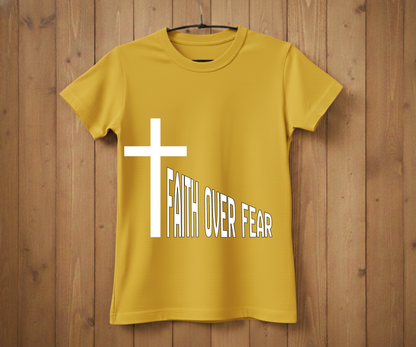 Yellow t-shirt with a white cross and 'Faith Over Fear' text on a wooden background