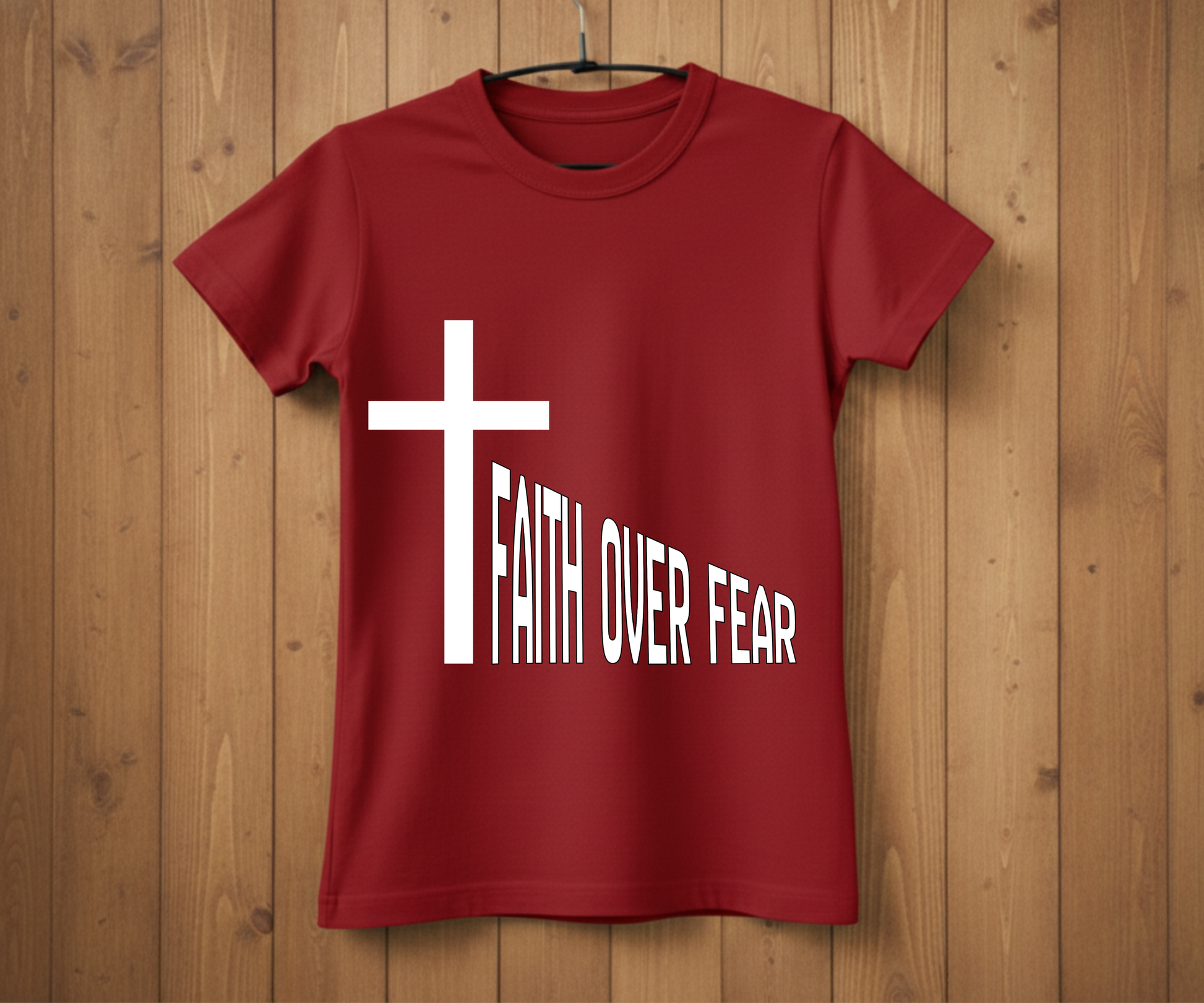 Red t-shirt with a white cross and 'Faith Over Fear' text on a wooden background