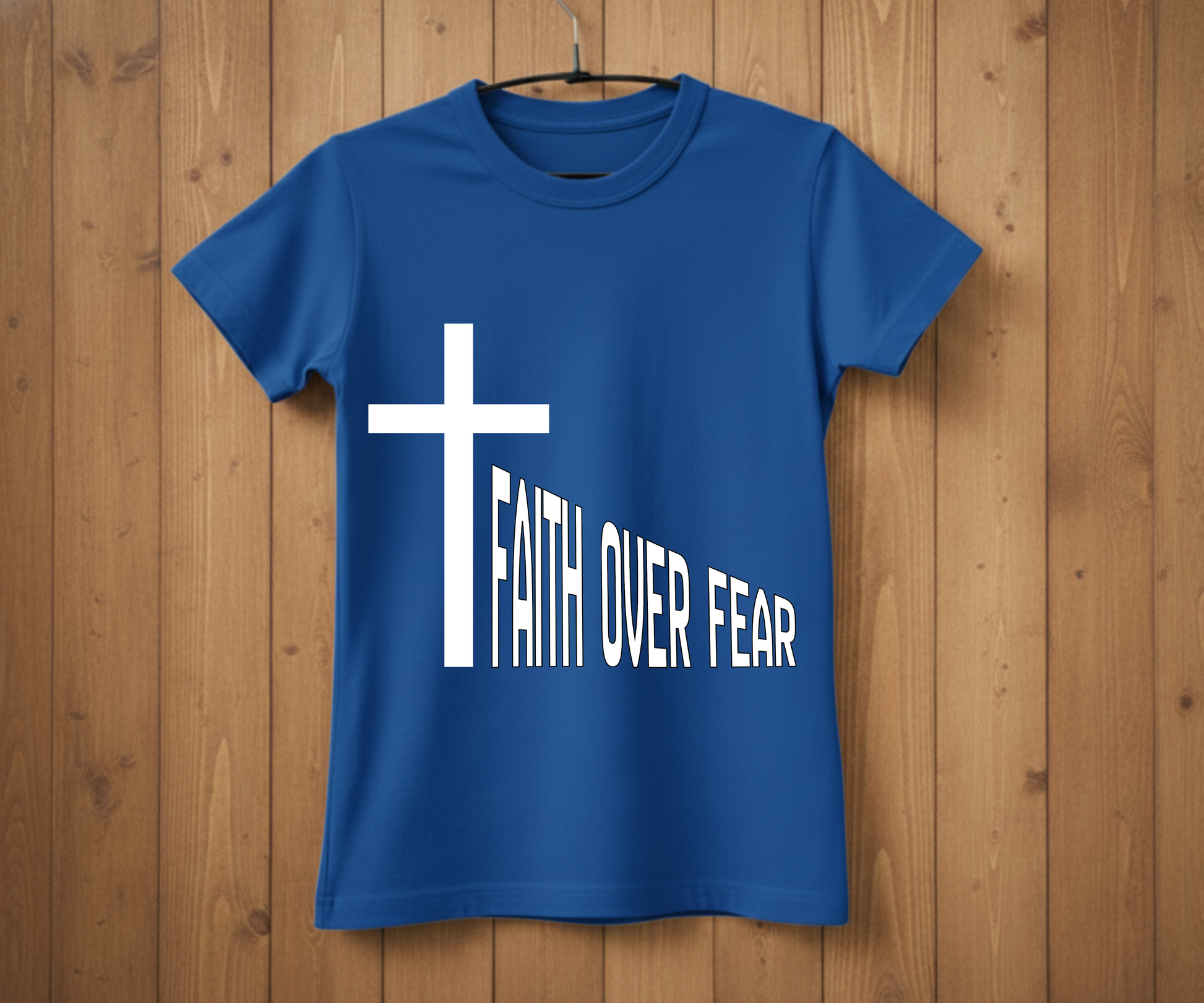 Blue t-shirt with a white cross and 'Faith Over Fear' text on a wooden background