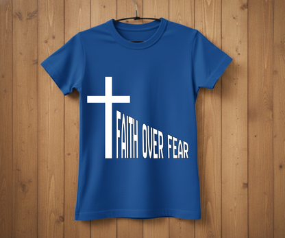 Blue t-shirt with a white cross and 'Faith Over Fear' text on a wooden background