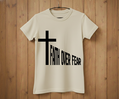 White t-shirt with a black cross and 'Faith Over Fear' text on a wooden background