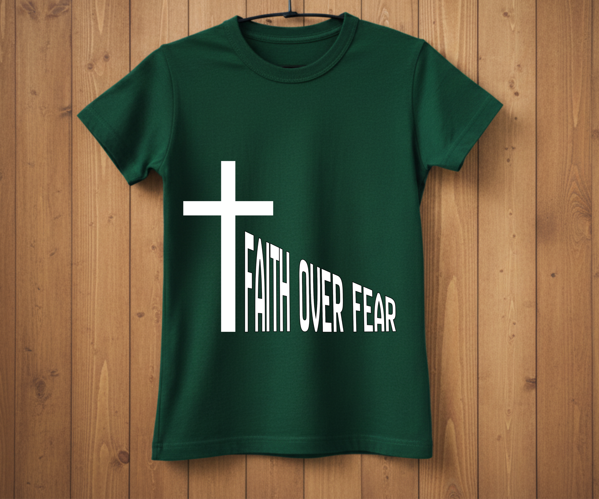 Green t-shirt with a white cross and 'Faith Over Fear' text on a wooden background
