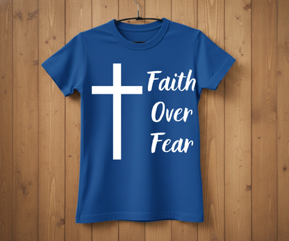 Blue t-shirt with a white cross and 'Faith Over Fear' text on a wooden background
