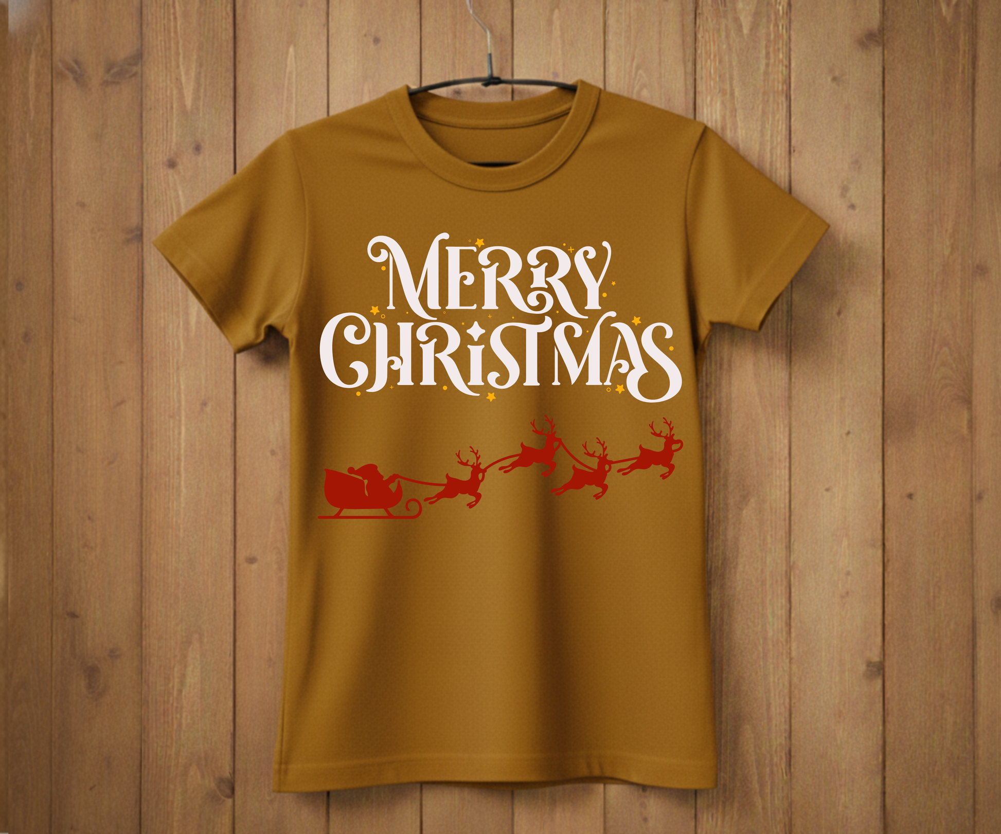 Brown t-shirt with 'Merry Christmas' text and Santa Claus graphic on a wooden background