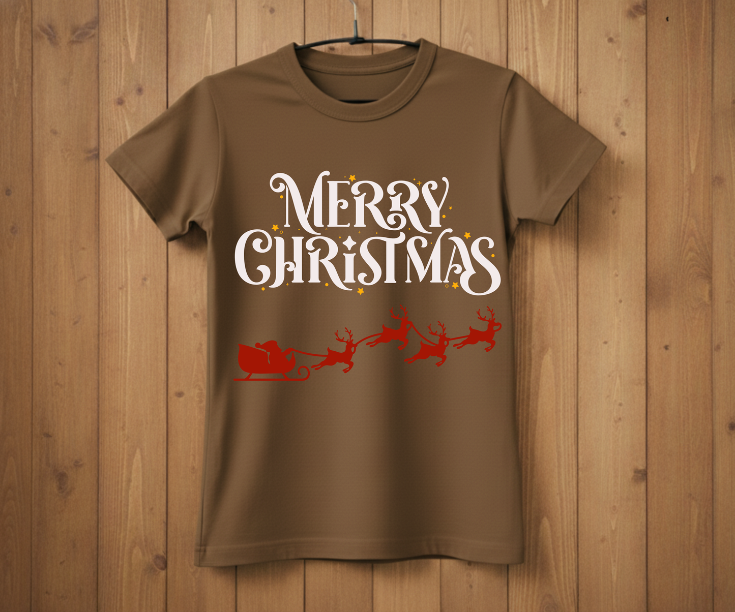 Brown t-shirt with 'Merry Christmas' text and Santa sleigh graphic on a wooden background