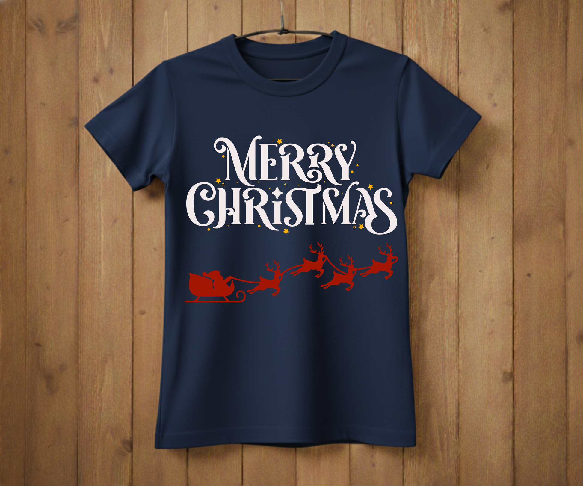 Navy blue t-shirt with 'Merry Christmas' text and Santa sleigh design on a wooden background