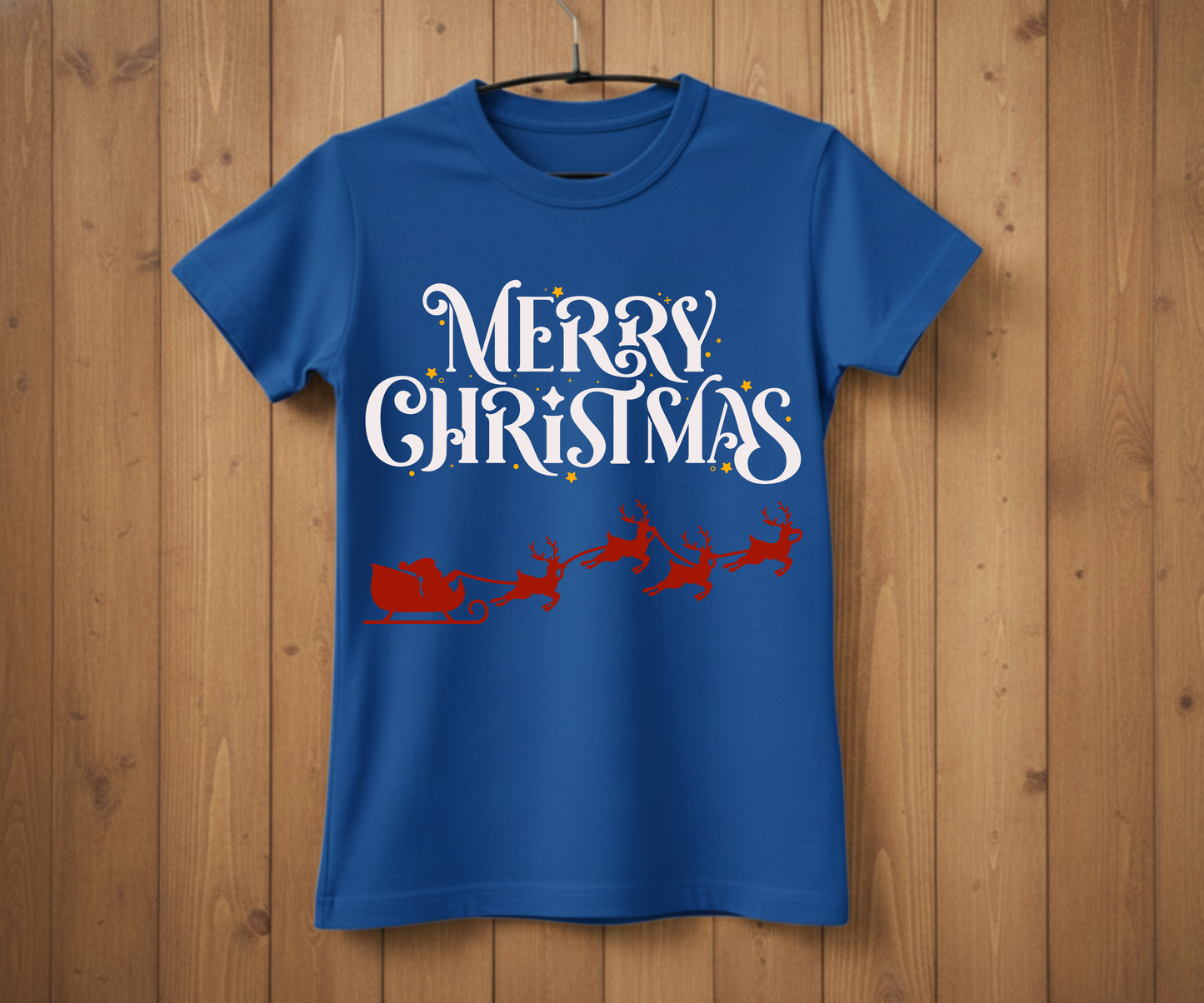Blue t-shirt with 'Merry Christmas' text and Santa Claus graphic on a wooden background