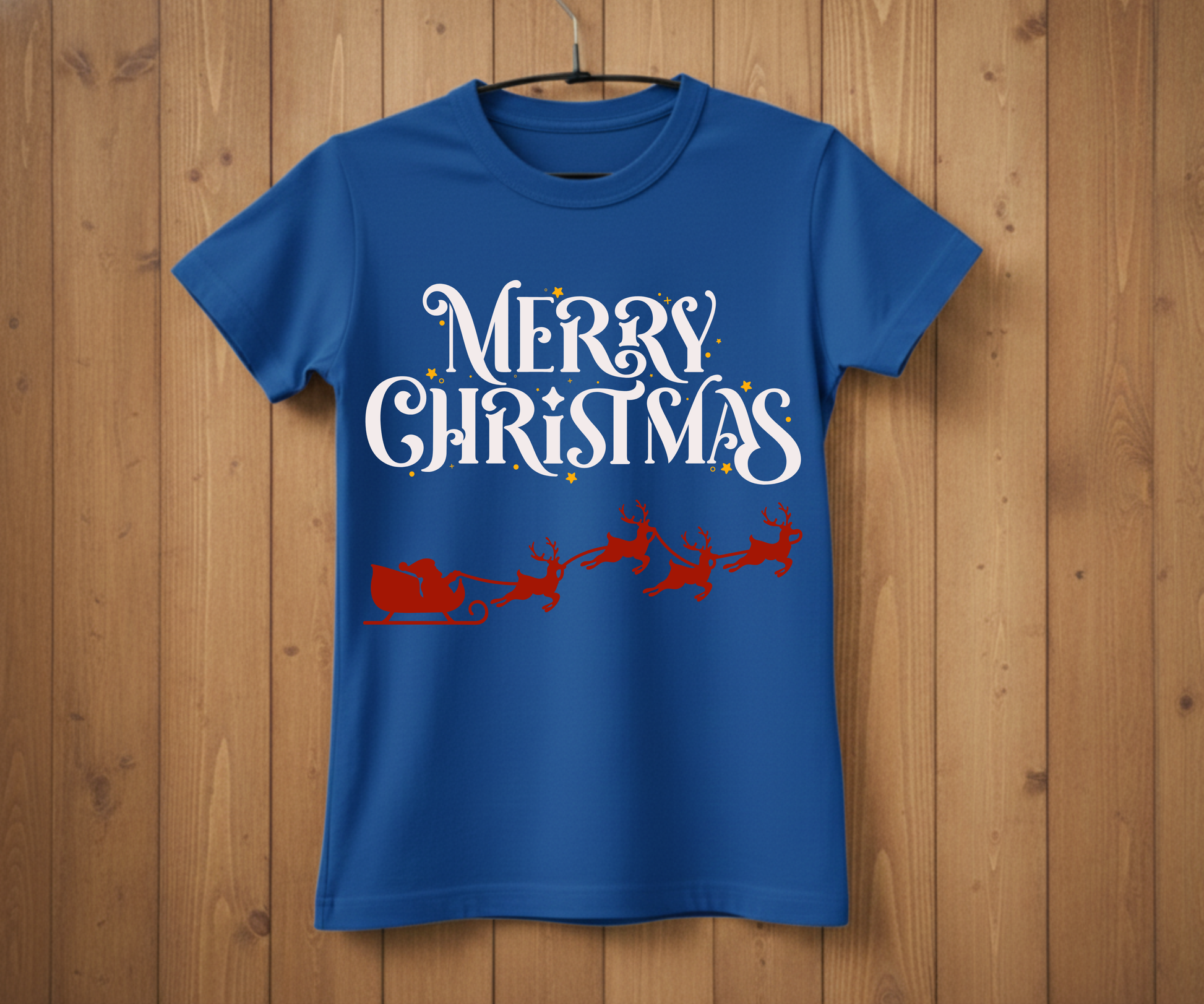 Blue t-shirt with 'Merry Christmas' text and Santa Claus graphic on a wooden background