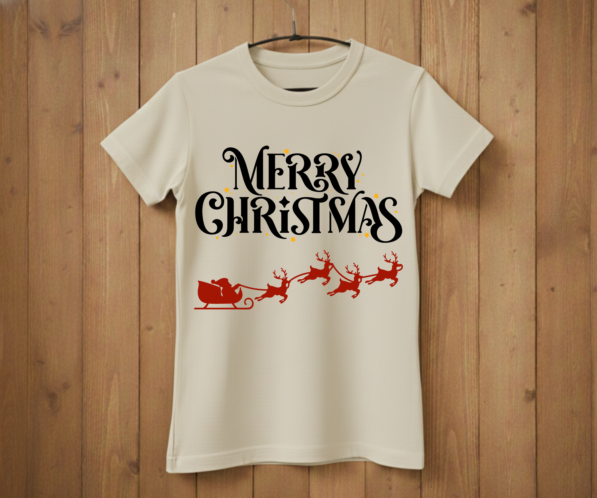 White t-shirt with 'Merry Christmas' text and Santa sleigh design on a wooden background