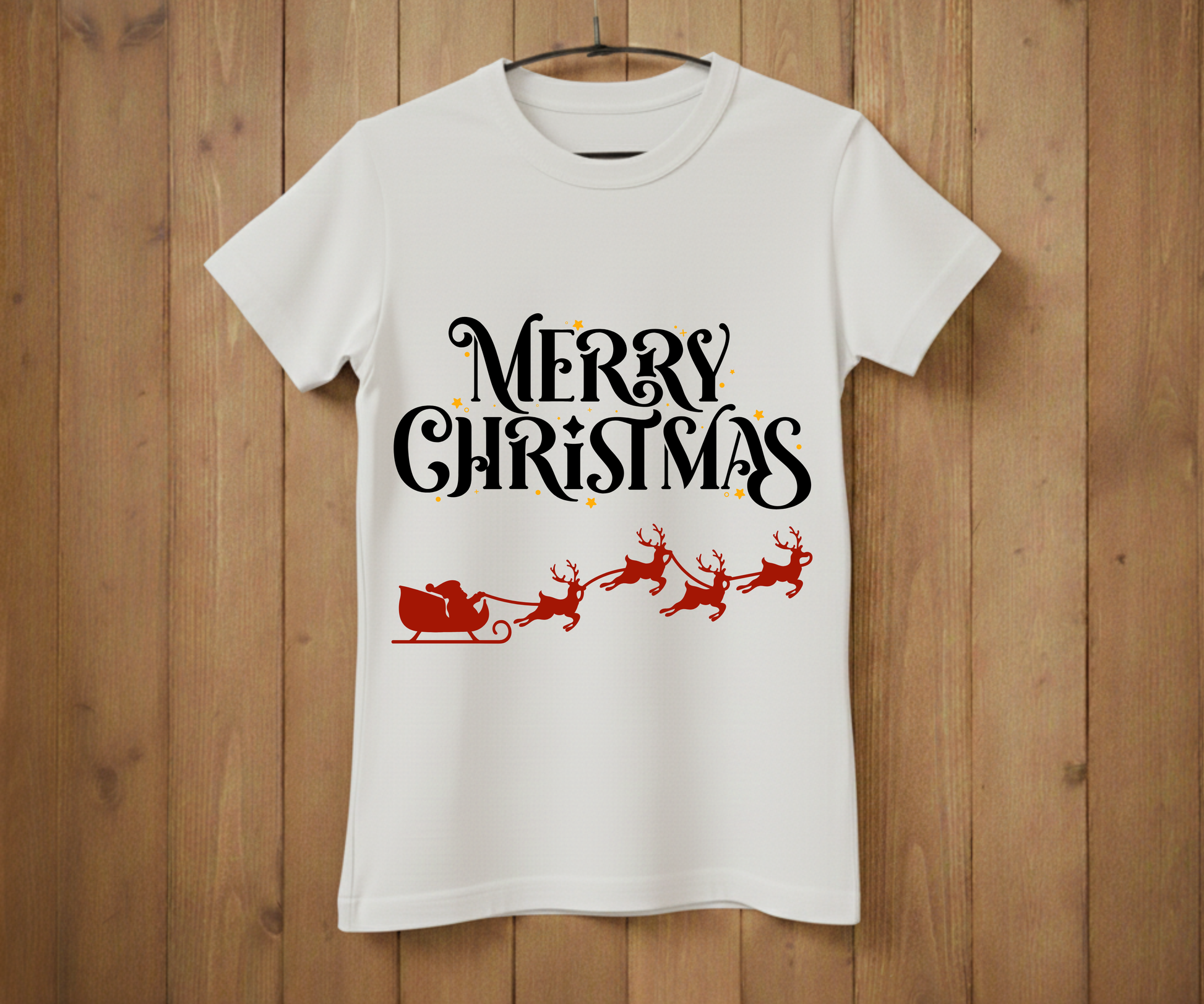 White t-shirt with 'Merry Christmas' text and Santa sleigh design on a wooden background