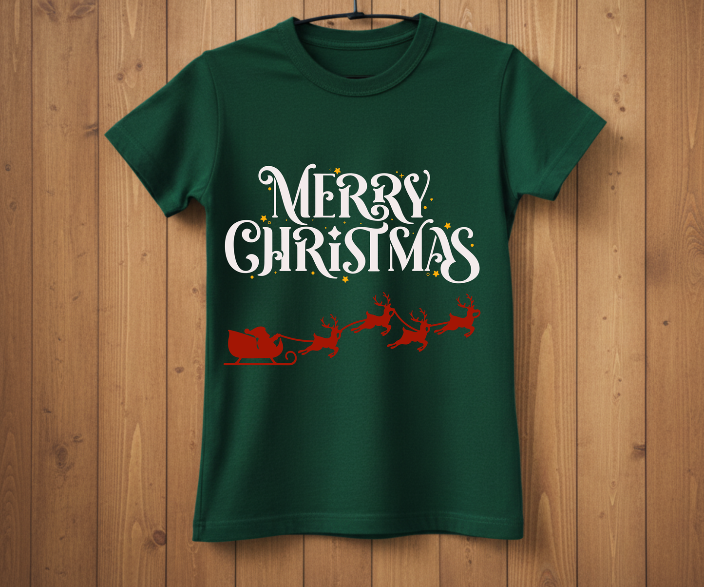Green t-shirt with 'Merry Christmas' text and Santa sleigh design on a wooden background